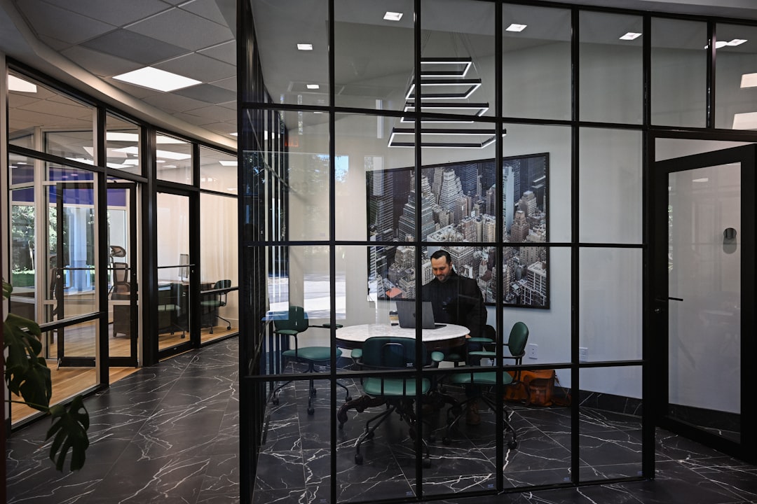 Northeast Ohio tech hub - Man working on laptop in modern office meeting room.