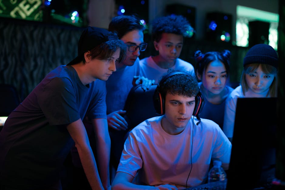 game industry news April 2026 - Group of diverse teenagers gaming together indoors, intense and focused.