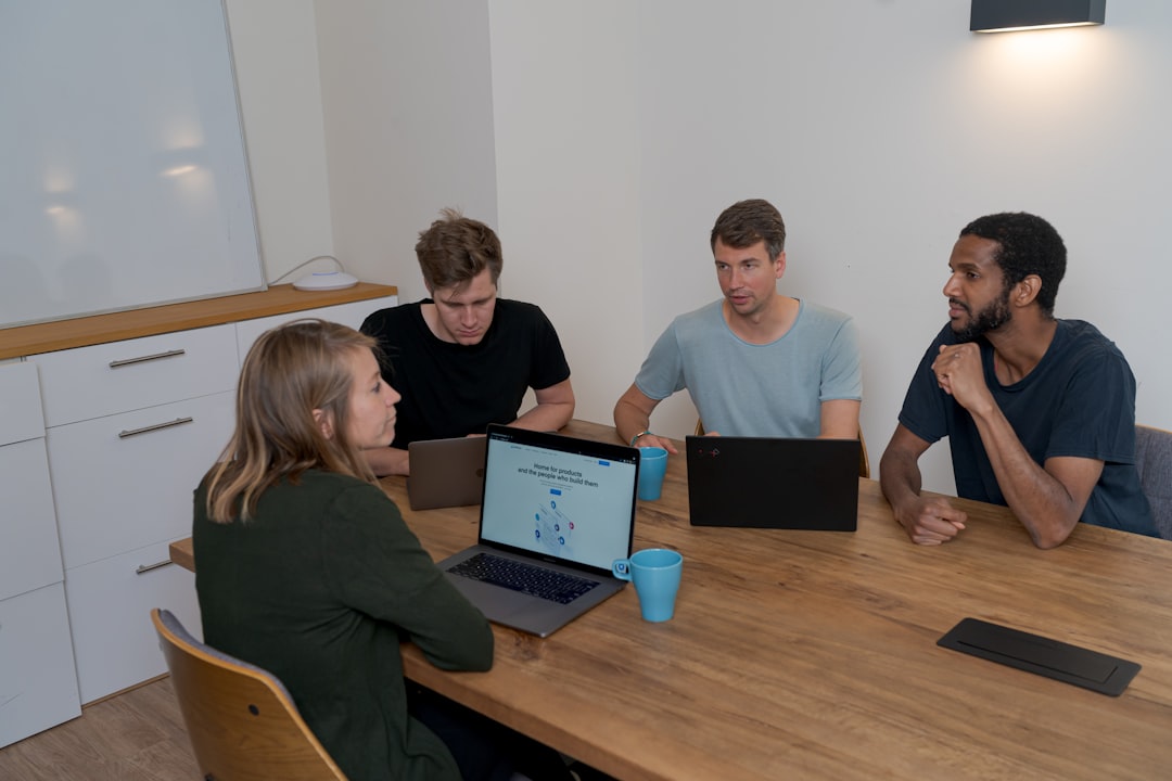 game dev news April 2026 - group of people sitting on chair in front of brown wooden table