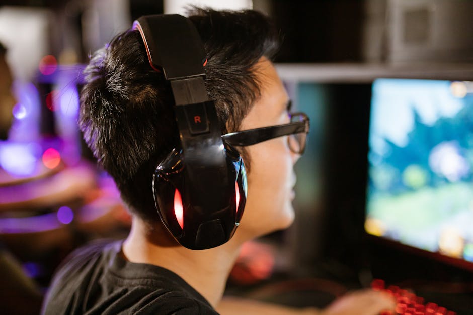 Unity 6 performance tips - A young gamer wearing headphones intensely focuses on his computer screen.