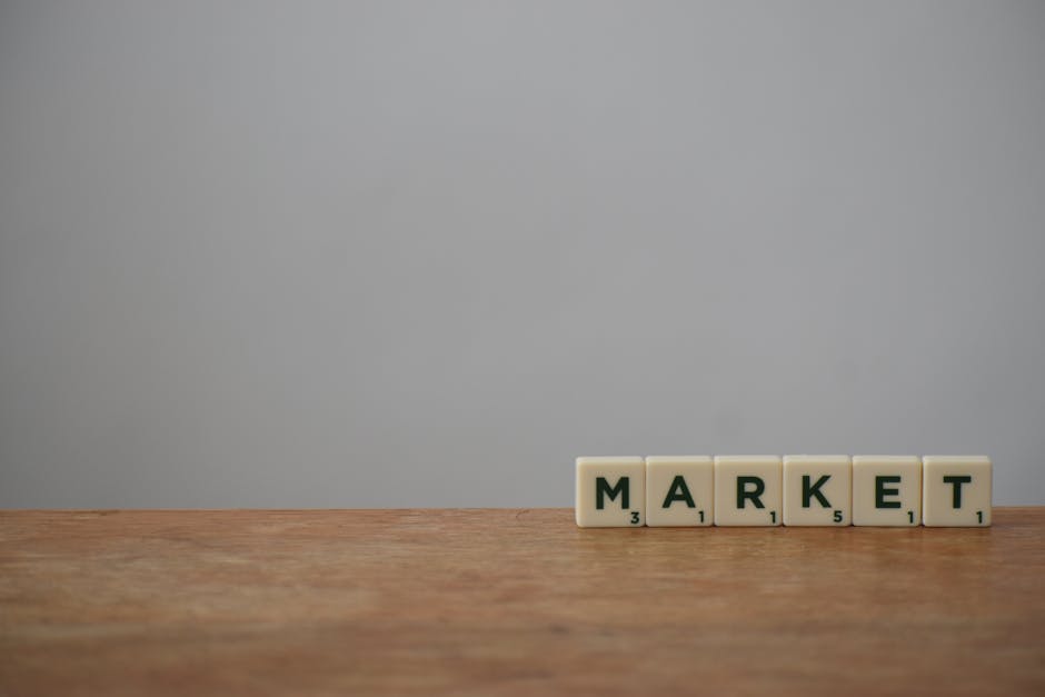 Steam wishlist tactics - Scrabble tiles spelling 'Market' on a wooden table with a minimalist background.