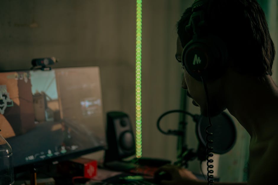 game industry news May 2026 - Focused gamer with headset playing a video game on a desktop computer indoors.
