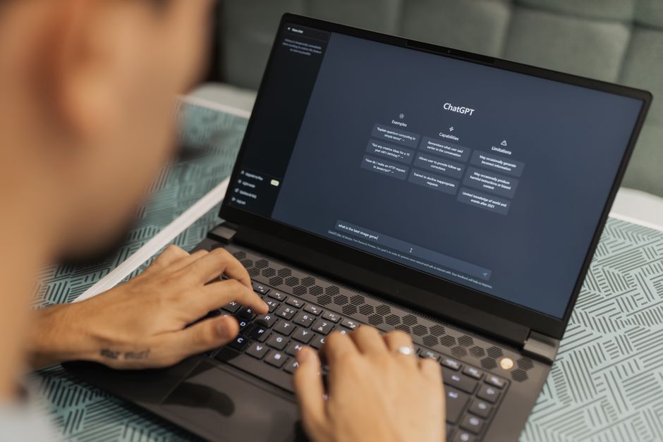 AI startup news - Close-up of a person typing on a laptop displaying the ChatGPT interface, emphasizing modern technology use.