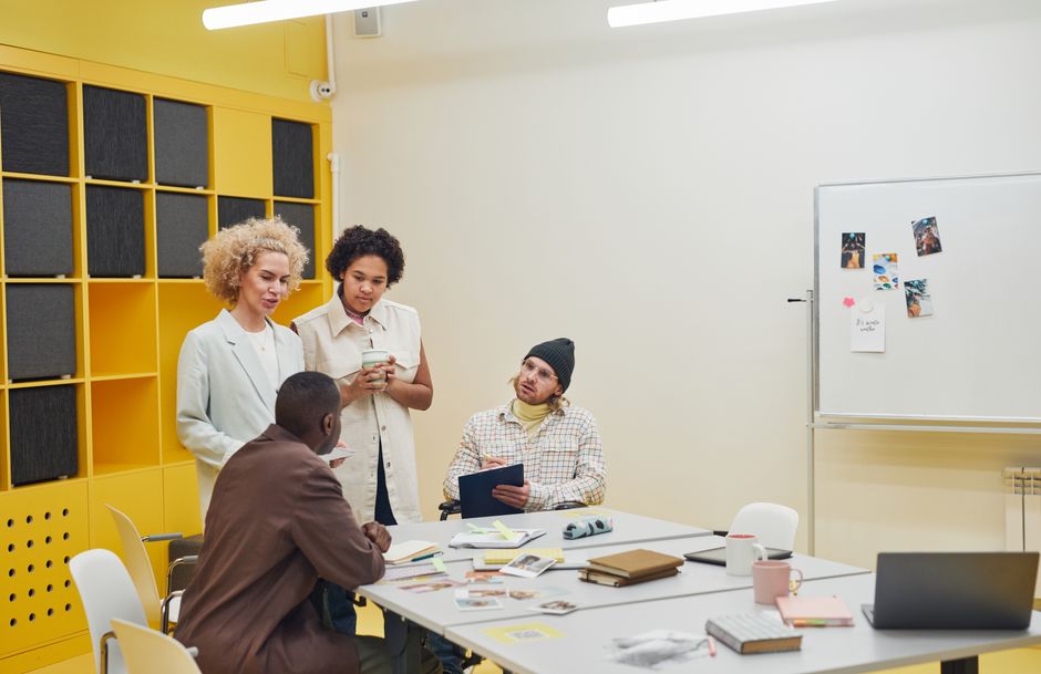 tech news roundup - A diverse group of professionals having a collaborative meeting in a modern office space.