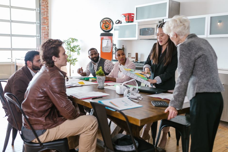 AI startup news - Colleagues engaged in a collaborative business meeting around a table in a modern office setting.